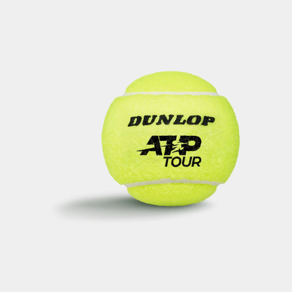 A Dunlop ATP Tour (4 Ball Tube) tennis ball, famed for tour-level performance, is shown in bright yellow against a plain white background with a soft shadow; DUNLOP ATP TOUR is printed on the ball in black.