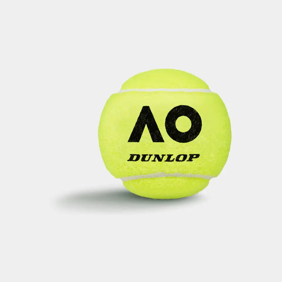 A bright yellow Dunlop Australian Open Tennis Ball from a 4 Ball Tube, featuring the black AO logo and DUNLOP text, casts a faint shadow on a white background—engineered for Grand Slam performance.
