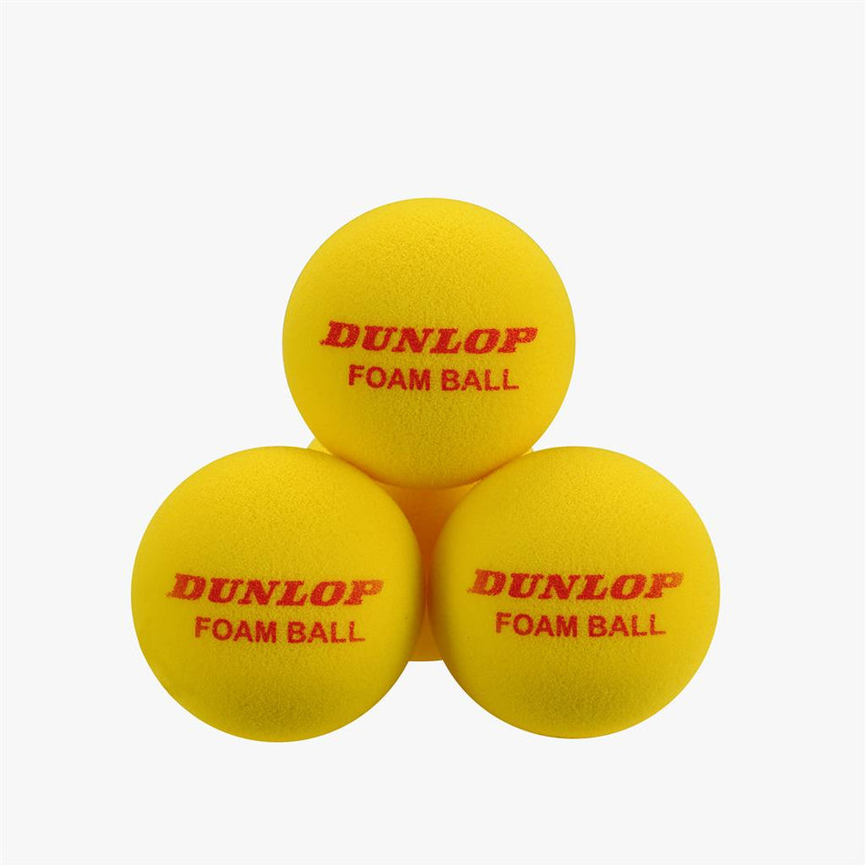 Three yellow Dunlop Indoor Foam Tennis Balls are stacked in a pyramid, each printed with the brand name in red. Ideal for kids learning tennis. Shown against a plain white background.