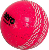 The Aero Quick Tech Glitter Junior Windball by Aero is a bright pink windball with white stitching, silver speckles, and the black aero logo—ideal as a coaching cricket ball for young players.