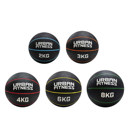 Five Urban Fitness Medicine Balls, each with unique weight labels and colorful stripes—ideal for boosting explosive power and enhancing your functional fitness routines.