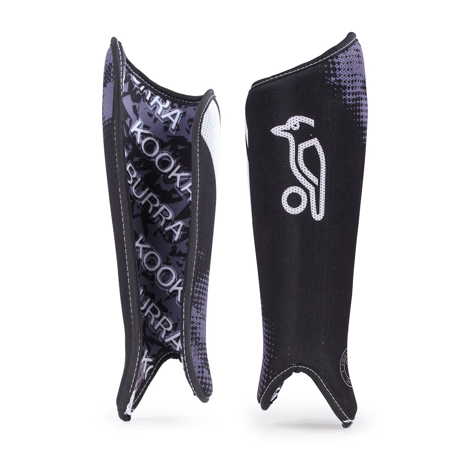 The Kookaburra Convert Shinguards are black with a white bird logo and KOOKABURRA branding inside. Ergonomically shaped, they feature a curved PVC shell and foam backing, shown standing upright in the photo.