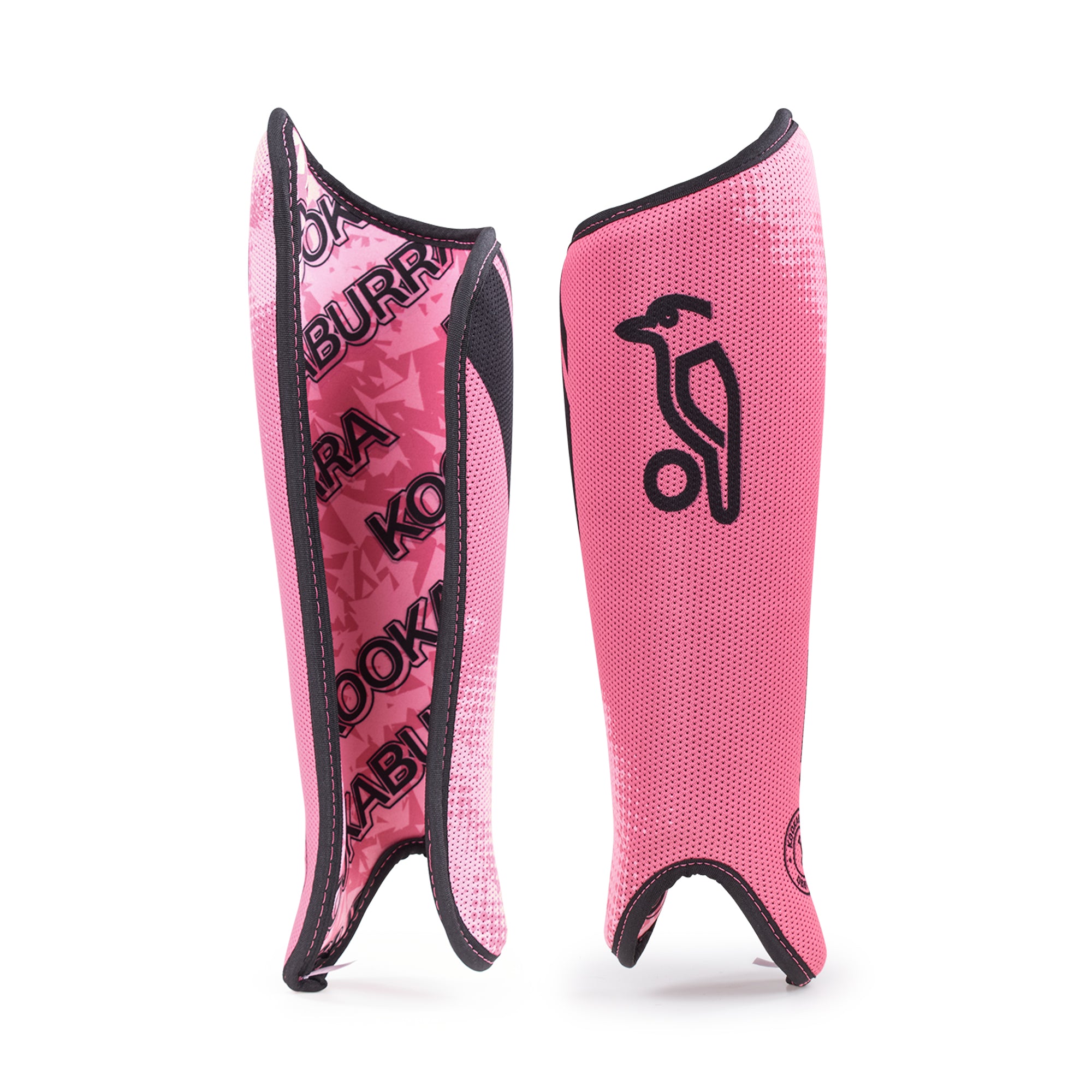 A pair of pink Kookaburra Convert Shinguards 2026 is shown: one displays the front with a black bird logo, while the other shows foam backing featuring a repeating KOOKABURRA pattern in black text.