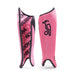 A pair of pink Kookaburra Convert Shinguards 2026 is shown: one displays the front with a black bird logo, while the other shows foam backing featuring a repeating KOOKABURRA pattern in black text.