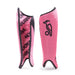 The Kookaburra Convert Shinguards in pink feature black accents, a bird logo on one guard, and bold KOOKABURRA lettering on the other. Made from sublimated fabric, they provide comfort and style for every game.