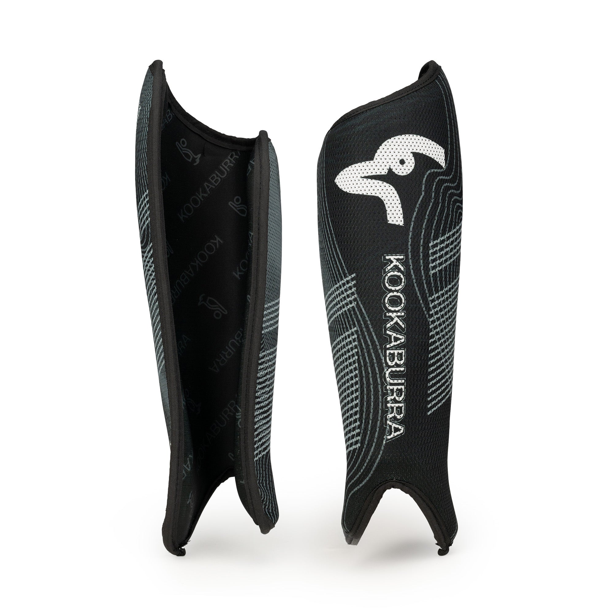 The Kookaburra Convert Shinguards 2026 are black shin guards with a white logo, curved ergonomic PVC design, textured pattern, and comfortable foam backing, shown standing upright against a white background.