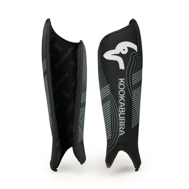 The Kookaburra Convert Shinguards 2026 are black shin guards with a white logo, curved ergonomic PVC design, textured pattern, and comfortable foam backing, shown standing upright against a white background.