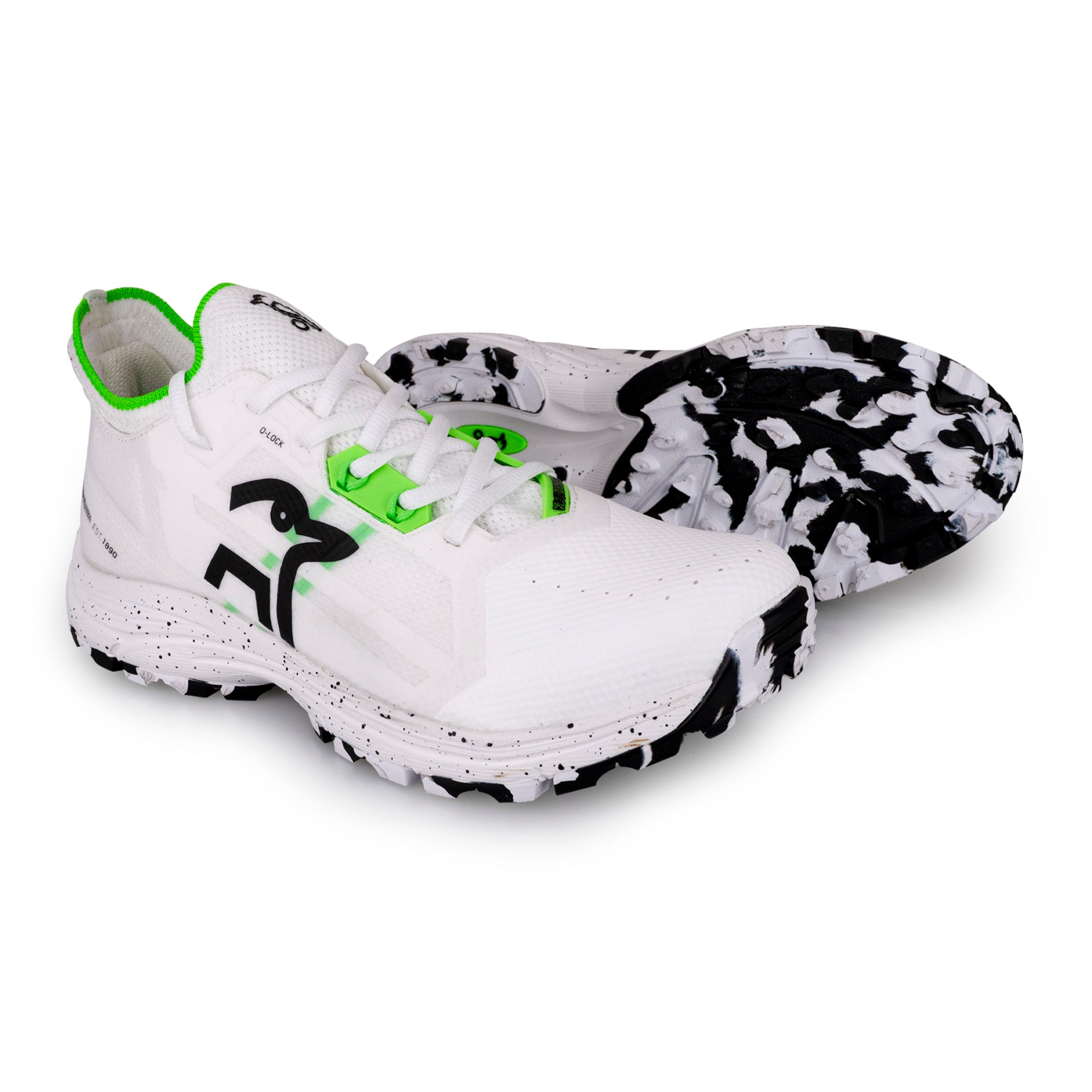 The Kookaburra Vapor Hockey Shoes by Kookaburra feature white uppers with black and neon green accents, a bold abstract logo, and a marbled traction outsole—ideal for anyone seeking a high-end hockey shoe.