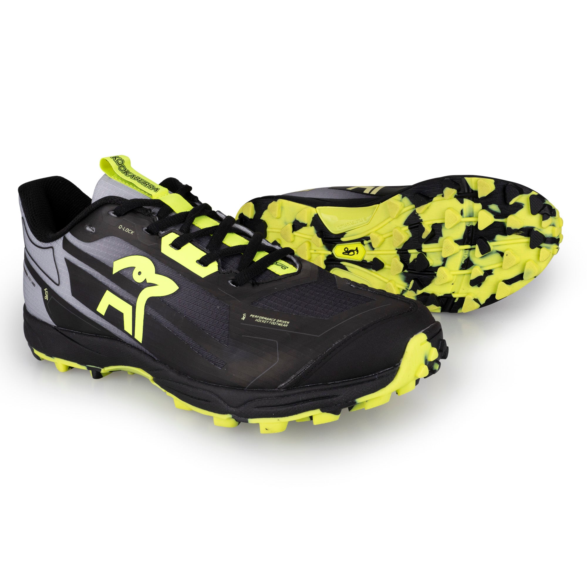 The Kookaburra Rogue Hockey Shoes by Kookaburra feature a black design with neon yellow accents and soles. One shoe stands upright, while the other is tilted to highlight the aggressive tread pattern and cushioned ETPU spring foam.