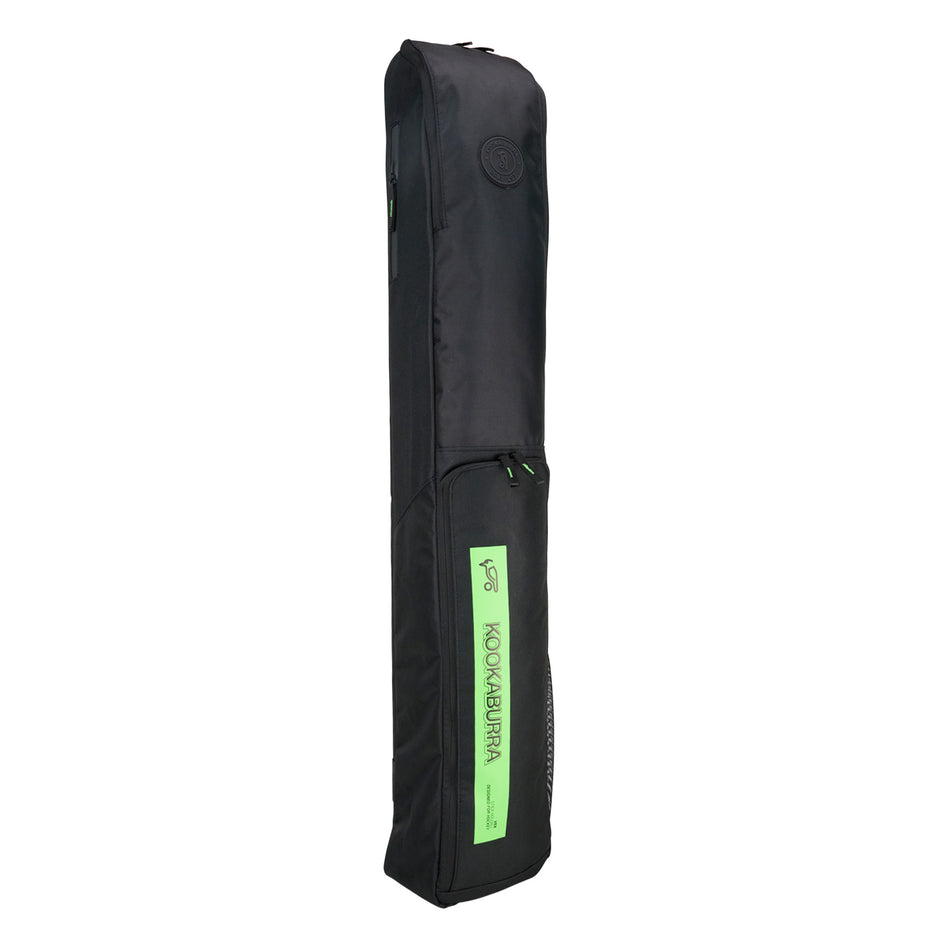 The Kookaburra Vex Hockey Kitbag 2025 is a black rectangular bag with a zippered top pocket, padded carrying strap, and a green front label with the Kookaburra brand name and logo.