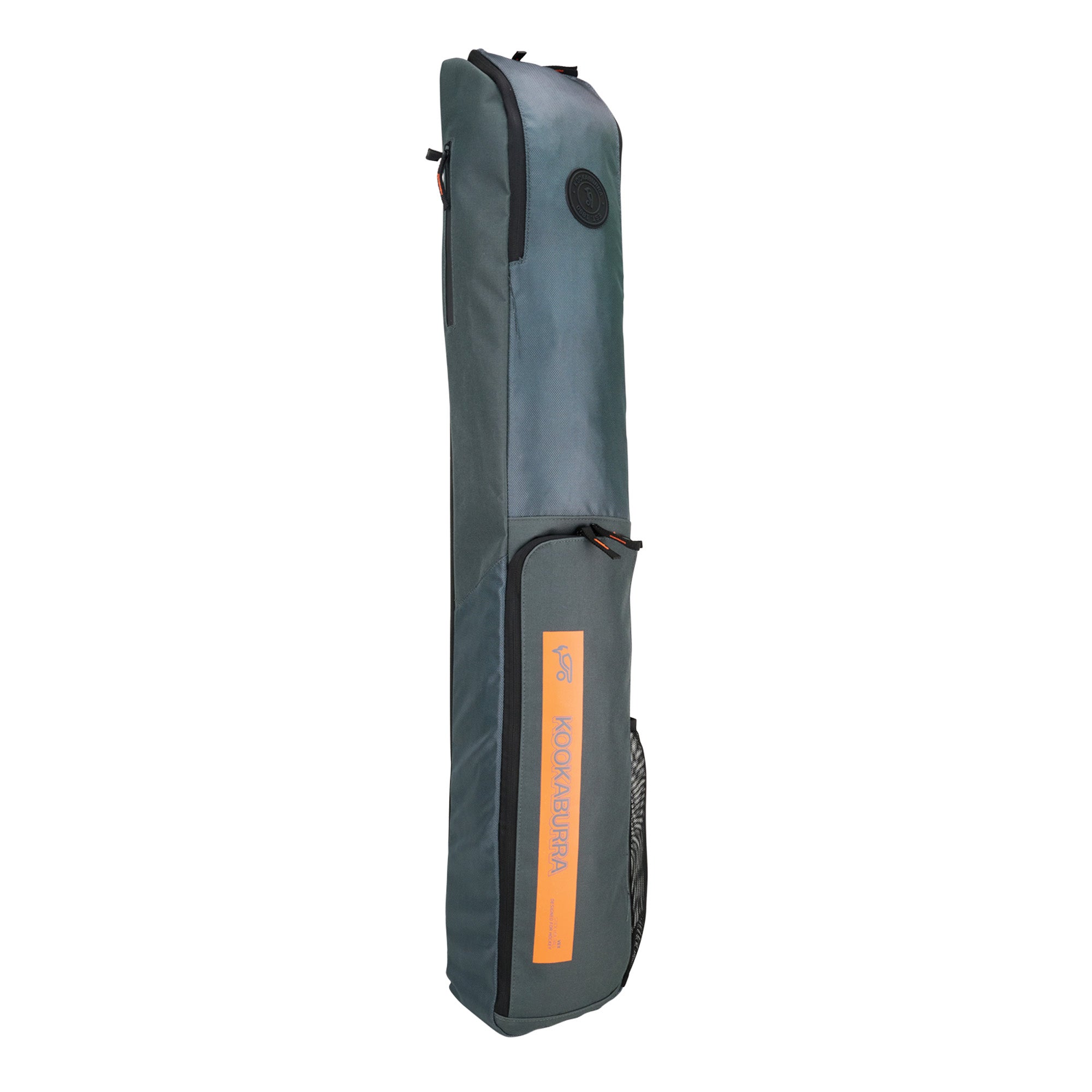The Kookaburra Vex Hockey Kitbag 2025 is a grey rectangular bag with black zippers and handle, an orange Kookaburra label on the front, a large top pocket, and is shown standing upright against a white background.