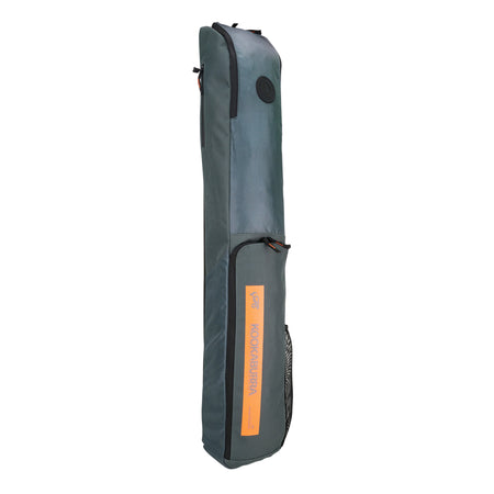 The Kookaburra Vex Hockey Kitbag 2025 is a grey rectangular bag with black zippers and handle, an orange Kookaburra label on the front, a large top pocket, and is shown standing upright against a white background.