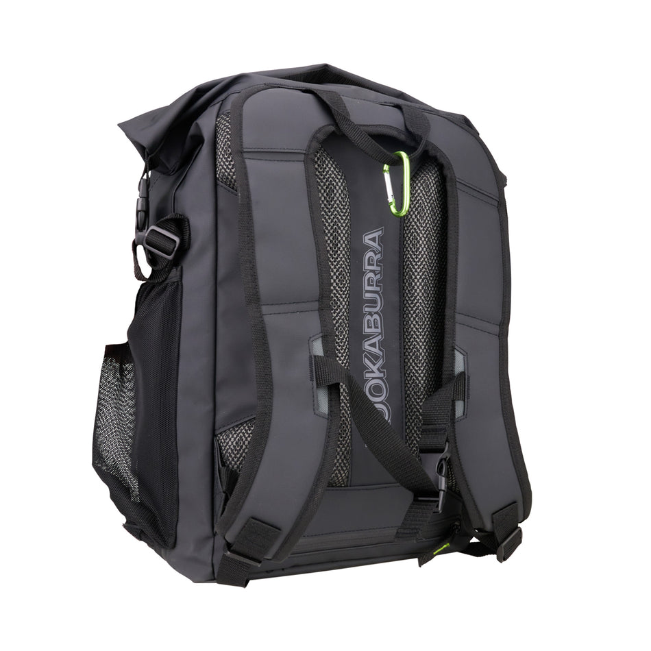 The Kookaburra Pro Hockey Rucksack 2025 is a black roll top backpack with padded shoulder straps, mesh side pockets, a small green carabiner, and a raincover for added protection. The Kookaburra logo is printed on the back panel.