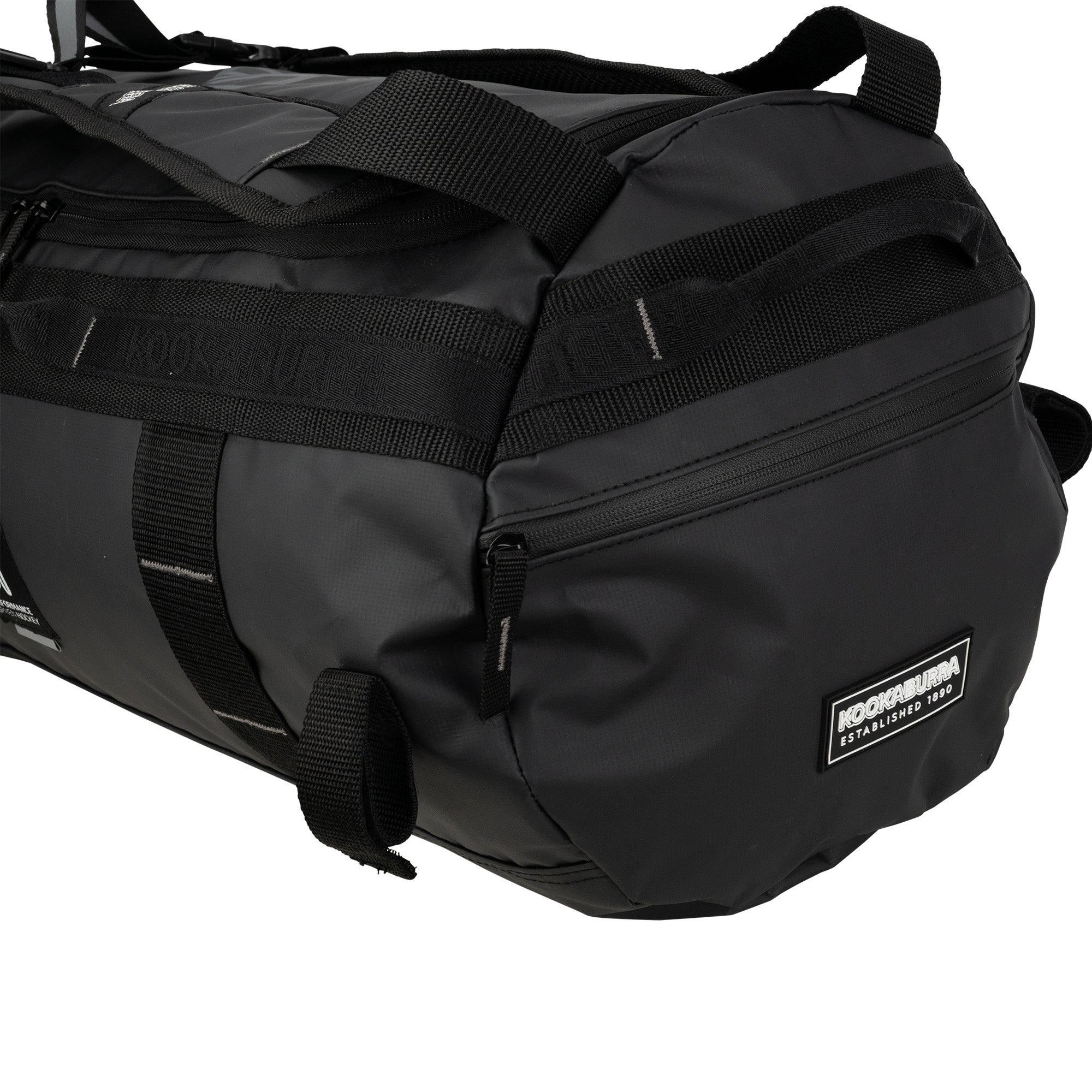 A close-up of the black Kookaburra Pro Switch Holdall shows its sturdy handles, detailed stitching, and the Kookaburra logo patch on the side.
