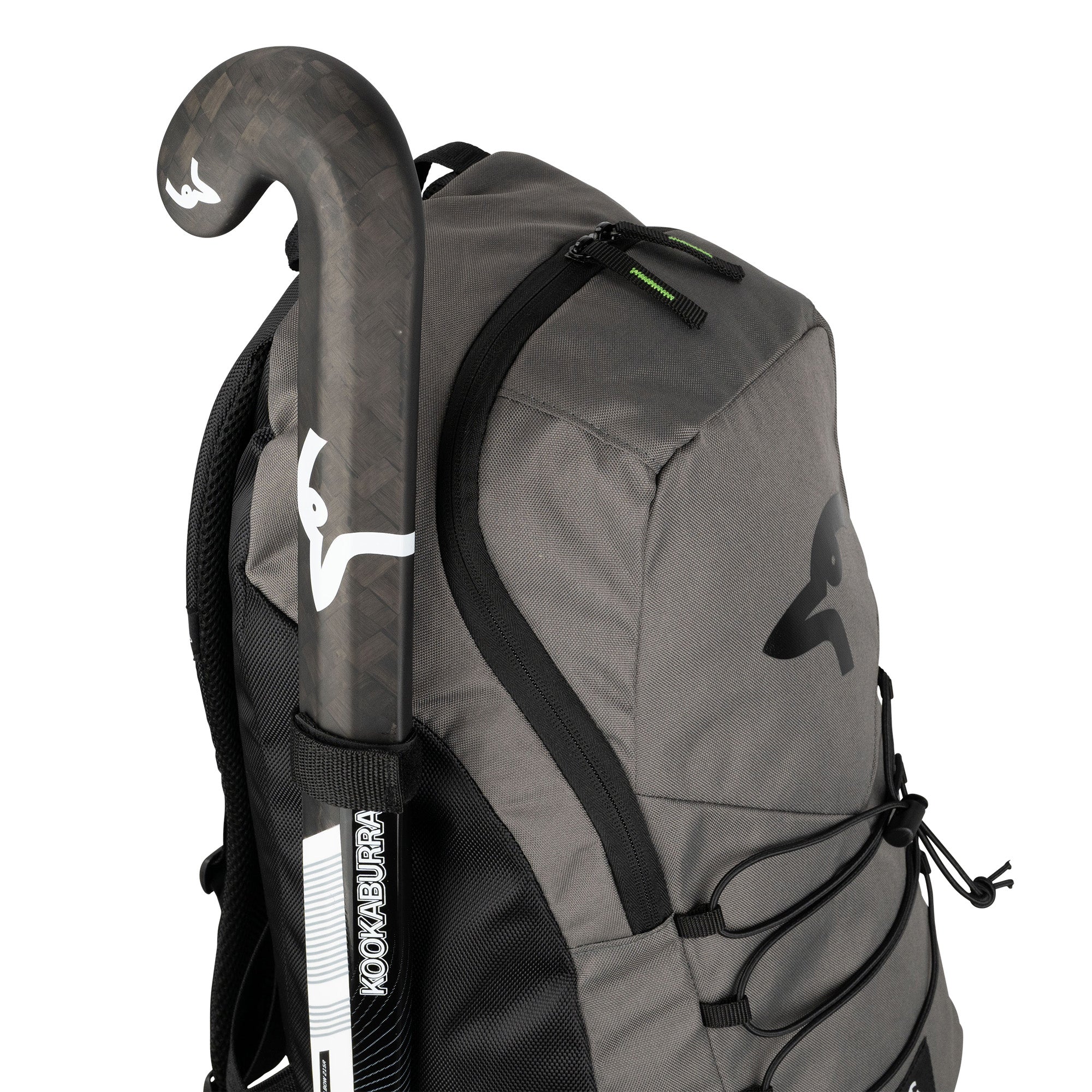 The Kookaburra Edge Rucksack 2026 in gray with black accents features ergonomic design and a padded laptop sleeve, while a black-and-white Kookaburra field hockey stick with the logo fits securely in its side pocket.