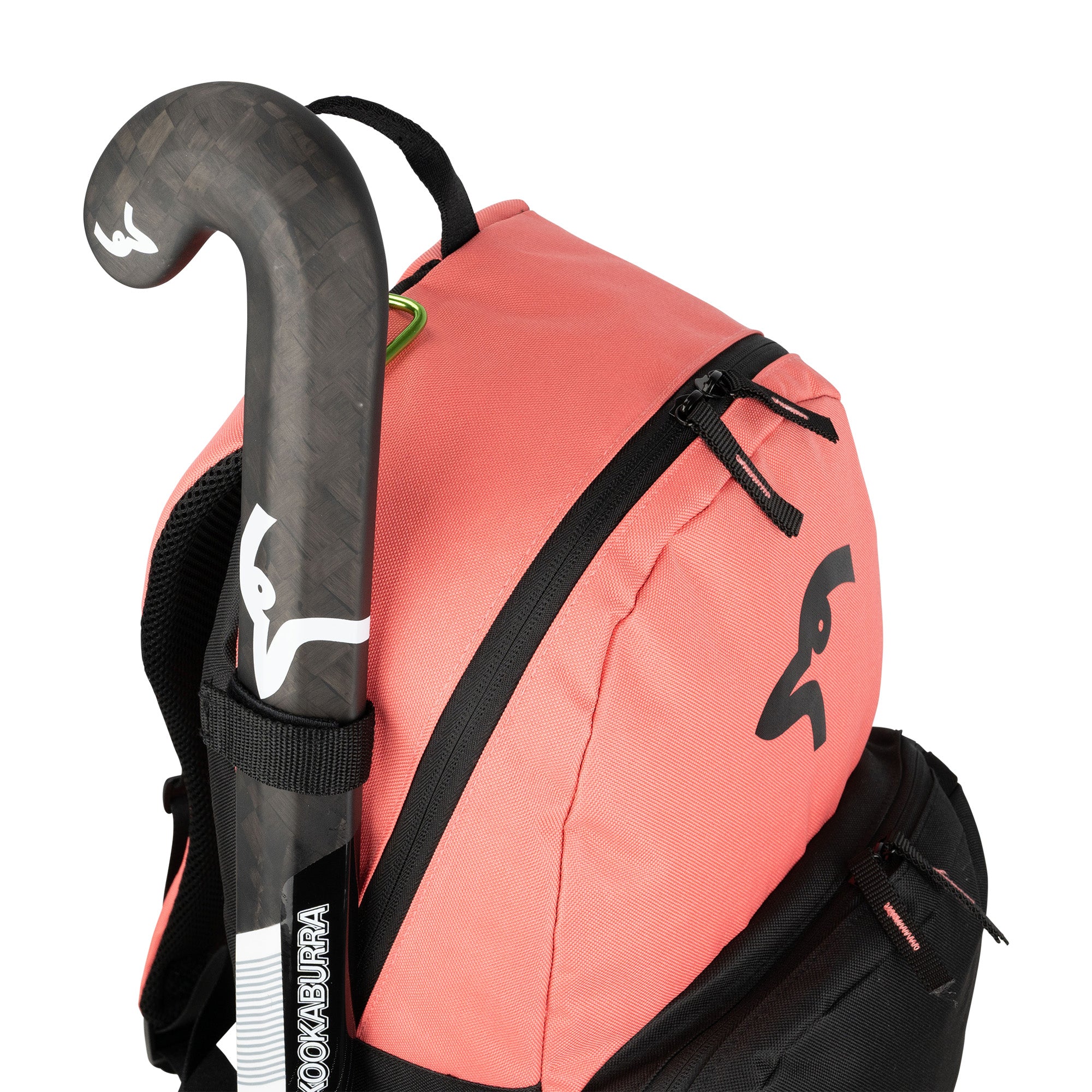 A close-up of the Kookaburra Flow Rucksack 2026 in pink, featuring black zippers, a black-and-white Kookaburra logo, adjustable shoulder straps, and holding a black field hockey stick with white markings in its external side pocket.