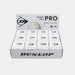 An open display box contains twelve individual Dunlop Pro White Squash Ball boxes, each labeled for advanced players and featuring the Dunlop logo along with “No.1 Ball on Tour!” text. This product is ideal as a low bounce squash ball, specifically designed for competitive play on glass courts.