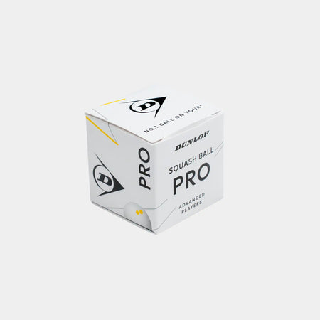 A plain gray background showcases a white box labeled “Dunlop Pro White Squash Ball (12 x 1 Ball Box)” by Dunlop, featuring black and yellow accents and the Dunlop logo. Designed for advanced players, this low bounce squash ball is ideal for use on a glass court.