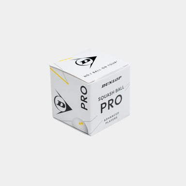 A plain gray background showcases a white box labeled “Dunlop Pro White Squash Ball (12 x 1 Ball Box)” by Dunlop, featuring black and yellow accents and the Dunlop logo. Designed for advanced players, this low bounce squash ball is ideal for use on a glass court.