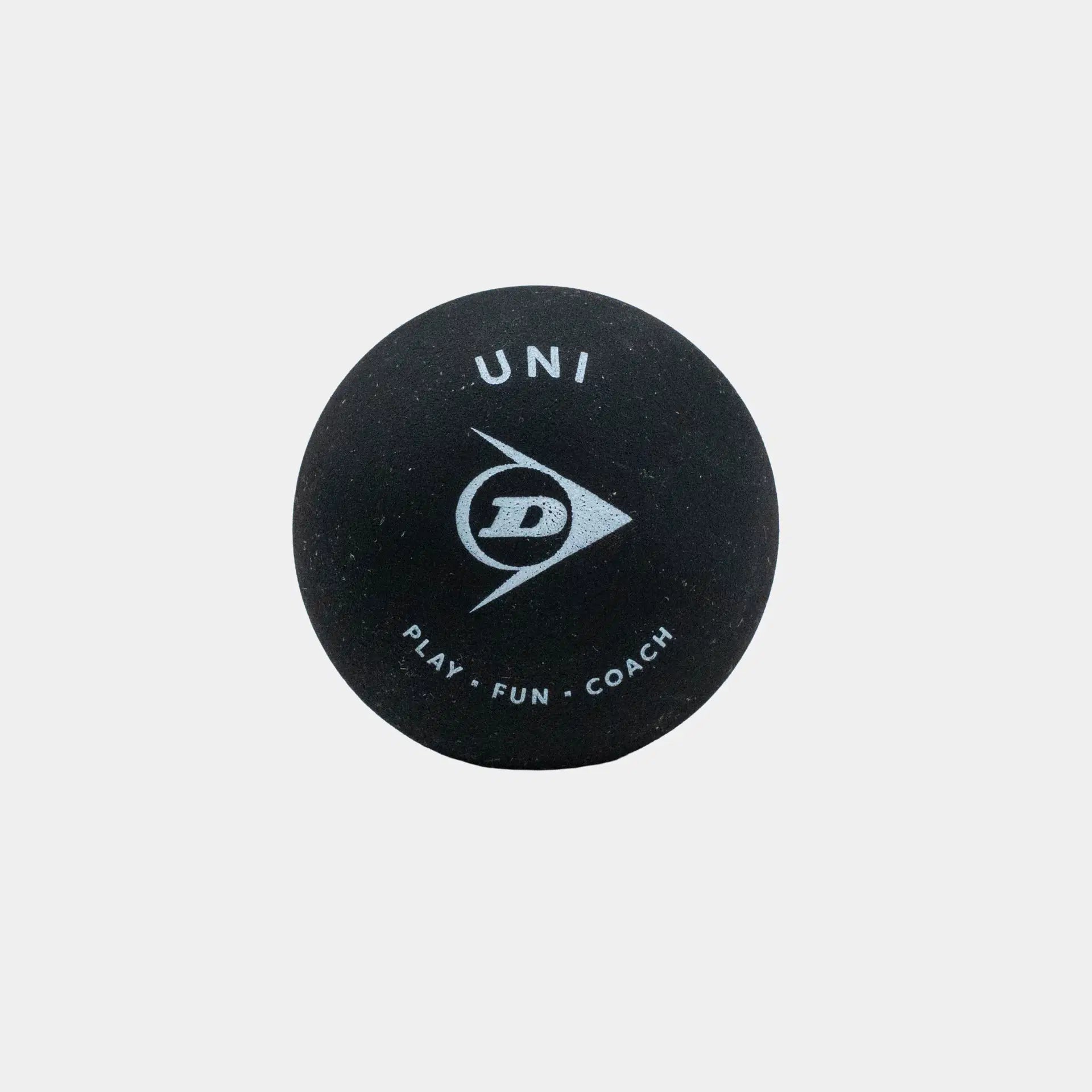 A box of three black Dunlop Uni Squash Balls, each featuring the UNI and PLAY · FUN · COACH wording and a white logo printed in white, shown against a plain white background—perfect for beginners or coaching sessions.