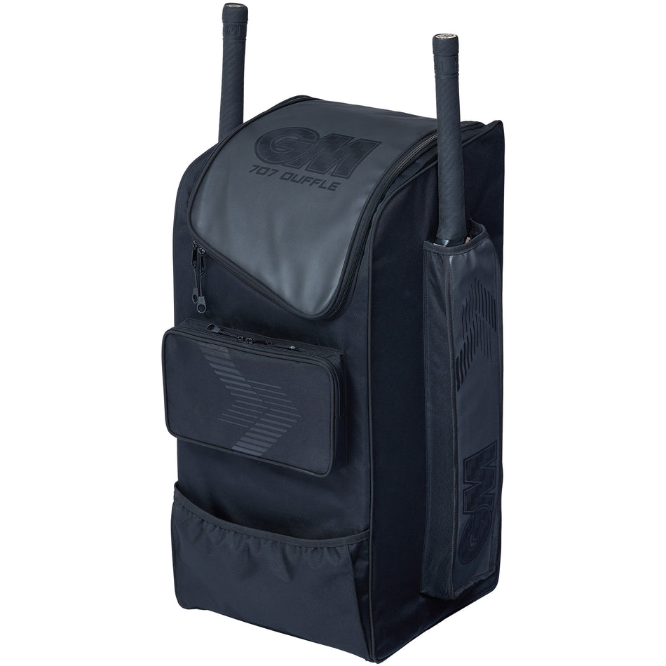 The Gunn & Moore 707 Duffle 2026 is a black kit bag with durable construction, zippered pockets, side compartments, GM logo on the front, and space for two cricket bats—perfect for junior players.