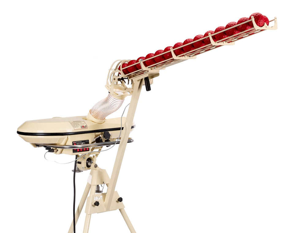A beige Bola Automatic 28 ball Feeder Unit, made by Bola, features a long, upward-sloping automatic ball feeder filled with red balls and stands securely on a tripod. Equipped with various control panels and wires, it’s perfect for solo batting practice and offers an electronic random delivery mode to keep every session challenging.