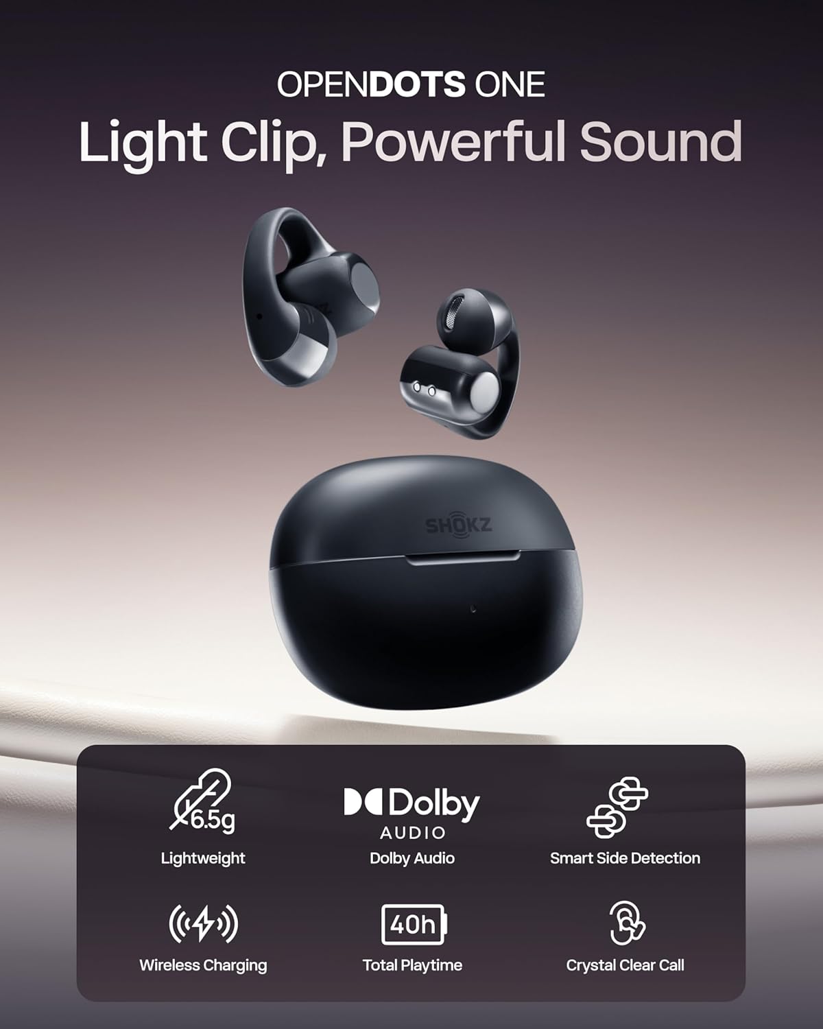 The Shokz OpenDots One by Shokz: black open-ear earbuds with open charging case, featuring 6.5g lightweight design, Dolby Audio, immersive and crystal clear sound, smart side detection, wireless charging, and 40h playtime.