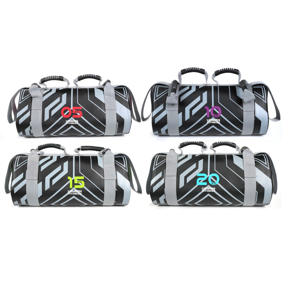 Four Urban Fitness Power Bags by Urban Fitness in black and gray with geometric patterns, each showing a different weight—5kg (red), 10kg (purple), 15kg (green), and 20kg (blue)—for full-body conditioning.