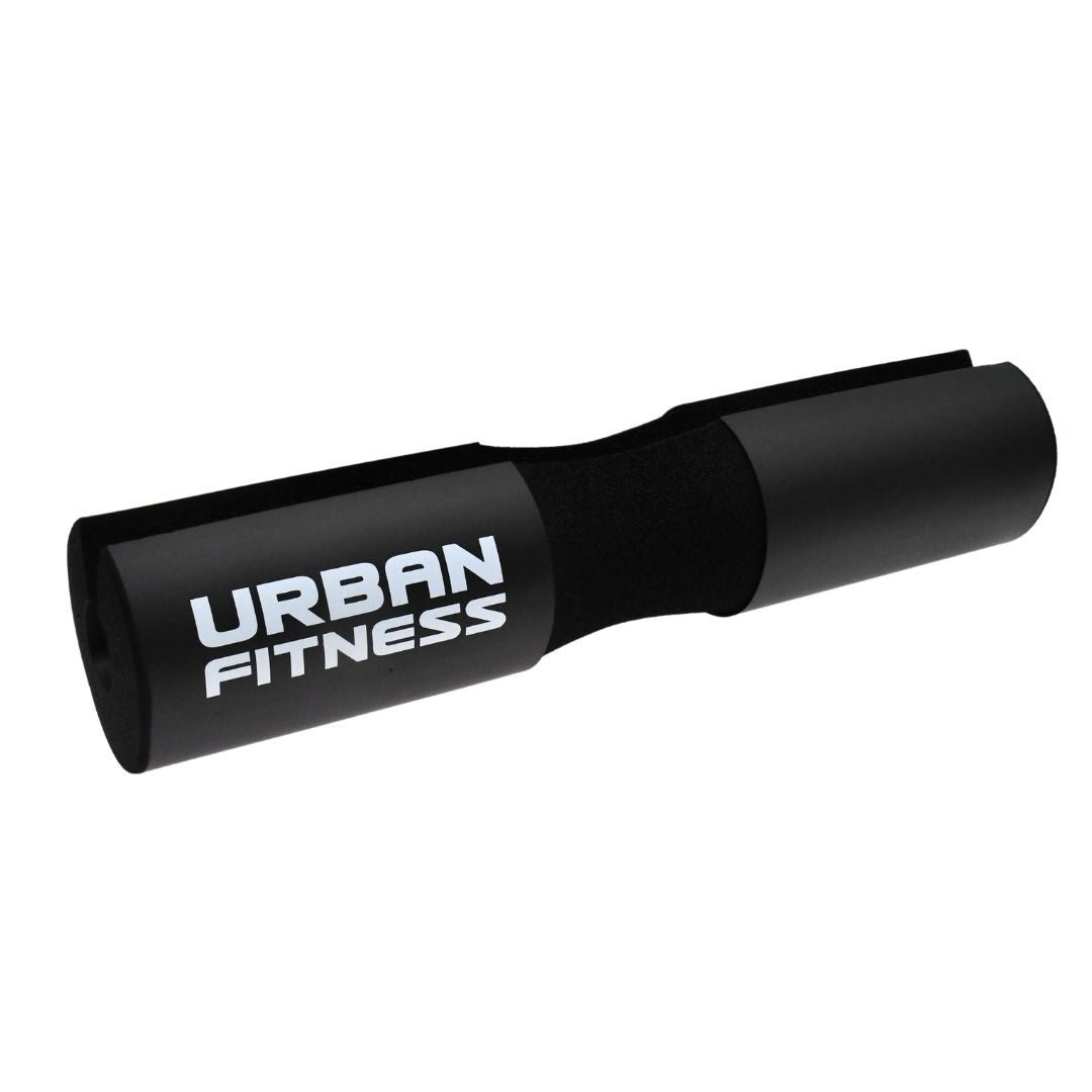 The Urban Fitness Barbell Squat Pad is a black high-density foam pad designed to offer superior neck and shoulder support during weightlifting, featuring the Urban Fitness brand name in bold white letters.