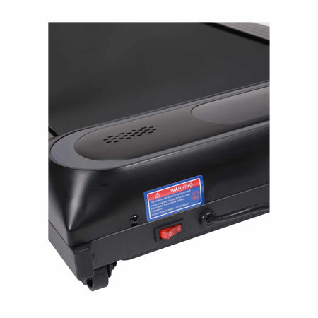 Close-up of the Urban Fitness Walking Treadmill base by Urban Fitness, highlighting its red power switch, warning label, speaker holes, running belt section, and integrated smart fitness tracking features.