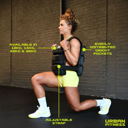 A woman in a gym performs a lunge wearing the black Urban Fitness Adjustable Weighted Vest. Labels show adjustable straps, evenly distributed weight pockets for progressive overload, and available weights: 10kg, 15kg, 20kg, 30kg. Urban Fitness logo appears.