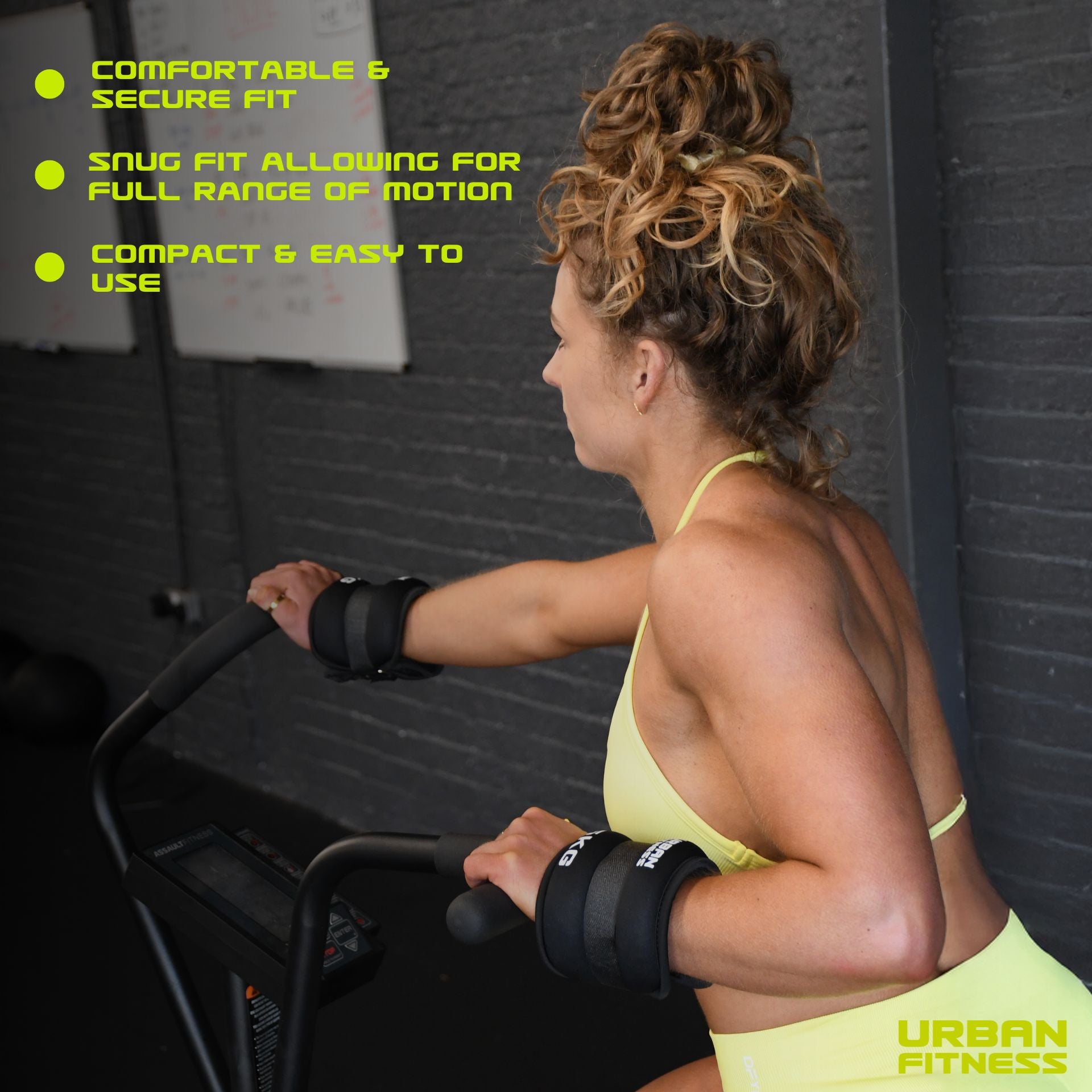 A woman in yellow sportswear uses a stationary bike while wearing Urban Fitness Neoprene Ankle/Wrist Weights, which offer a comfortable, secure fit for full range of motion; they are compact and easy to use.