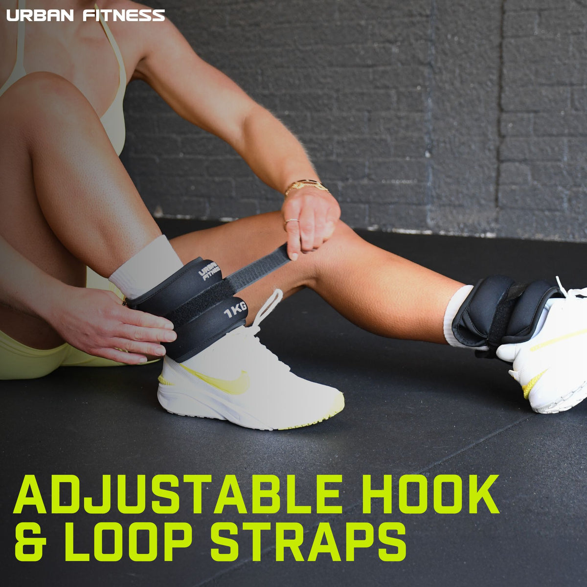 A person secures Urban Fitness Neoprene Ankle/Wrist Weights with adjustable hook & loop straps over white sneakers. "Adjustable Hook & Loop Straps" is shown, with the Urban Fitness logo in the corner.