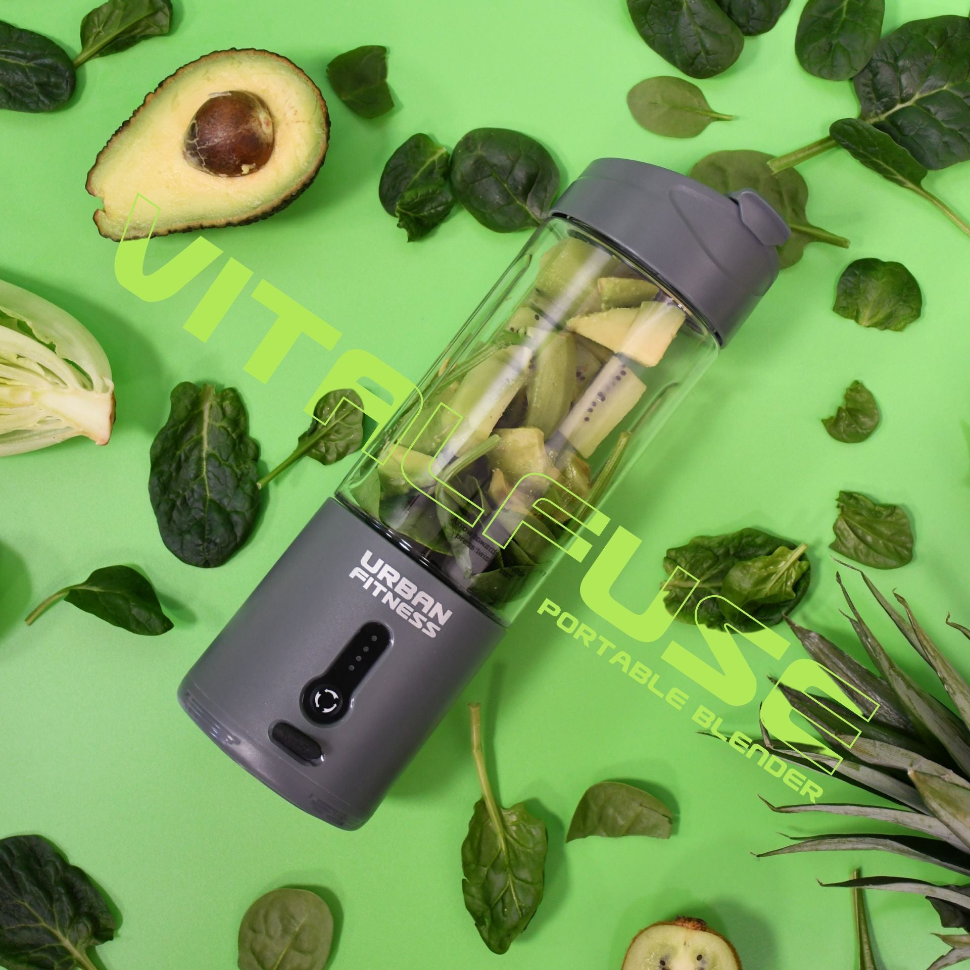 An Urban Fitness VitalFuse Portable Blender filled with avocado and greens rests on a green background amid spinach leaves, avocado halves, and other greens. "Urban Fitness VitalFuse Portable Blender" is displayed across the image.