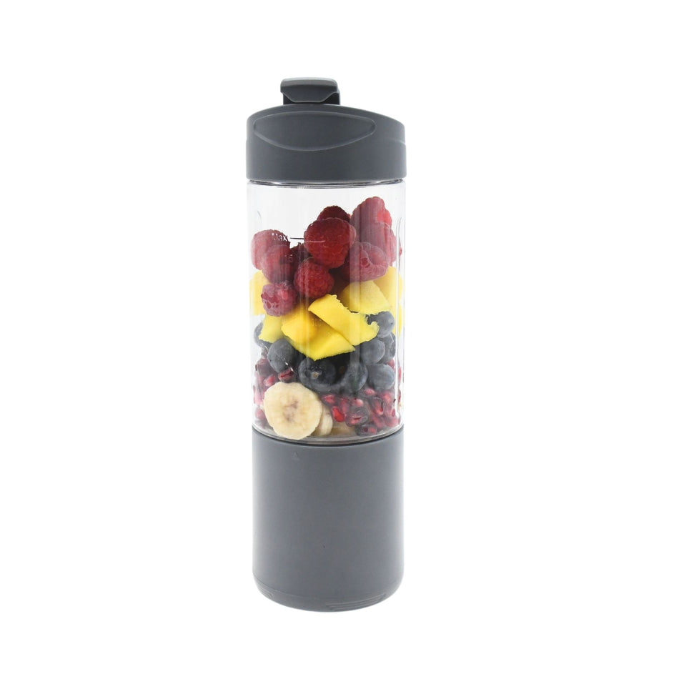 The Urban Fitness VitalFuse Portable Blender by Urban Fitness, filled with layers of raspberries, mango, blueberries, banana, and pomegranate seeds, delivers on-the-go nutrition against a crisp white background.