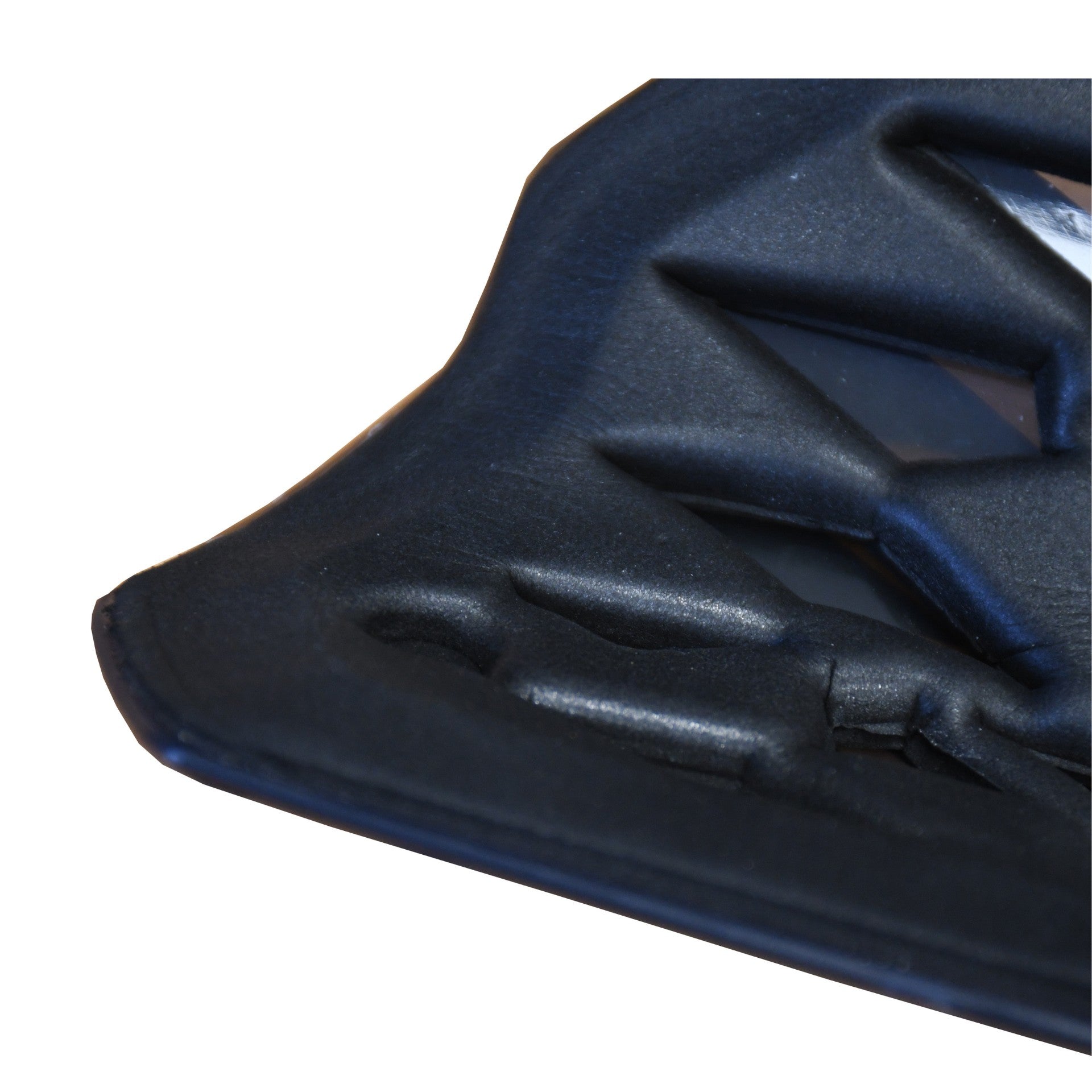 Close-up of the Precision Training Precision Pro Fusion Flex Shin Guards' black, textured corner with geometric patterns and raised sections, highlighting their elite protection and flexibility against a white background.