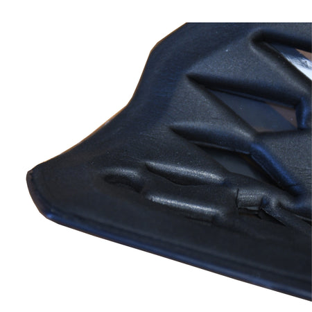 Close-up of the Precision Training Precision Pro Fusion Flex Shin Guards' black, textured corner with geometric patterns and raised sections, highlighting their elite protection and flexibility against a white background.