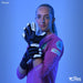 A female goalkeeper in a pink jersey and black Precision Elite 3.0 Quartz Goalkeeper Gloves by Precision Training poses against a blue background, confidently showcasing her gloves' elite grip. Brand logos are visible in the corners.