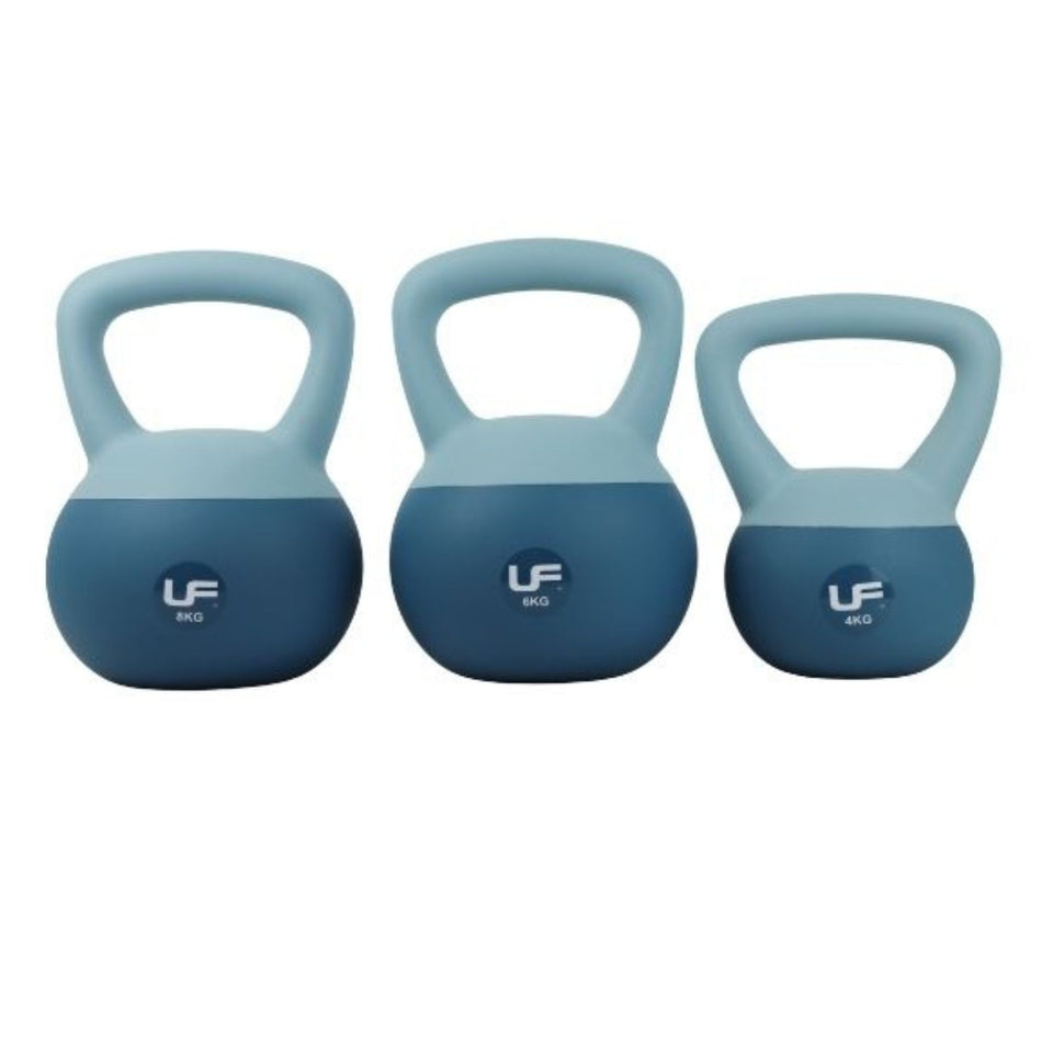 Three Urban Fitness Dual Soft Kettlebells in blue, labeled 8kg, 6kg, and 4kg from left to right, are shown side by side. Each features a wide handle—ideal for functional training and home workouts. Brand: Urban Fitness.