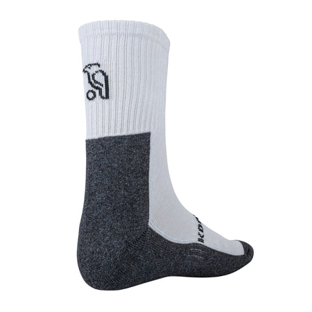 The Kookaburra Air Flex Socks by Kookaburra are white and dark gray cricket socks with a ribbed upper, cushioned sole, and a black logo on the side, shown on a mannequin foot facing left.