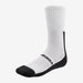 A pair of Kookaburra Air Flex Cricket Socks by Kookaburra, in white with black toes and heels, ribbed cuffs, and "Kookaburra" branding on the sole, displayed against a plain white background.