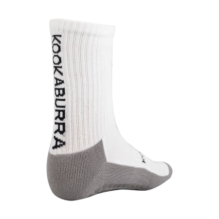 The Kookaburra Grip Socks are white and gray athletic cricket socks featuring KOOKABURRA in black along the side, reinforced gray heel and toe areas, and a cushioned sole for comfort during active play.