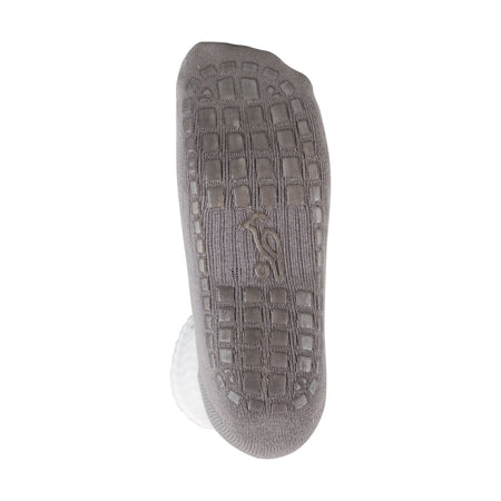 The sole of the Kookaburra Grip Socks by Kookaburra is shown from the bottom, displaying a grid-textured, cushioned surface and a small embroidered penguin logo near the arch with heel and toe areas clearly visible.