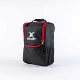 The black/red Gilbert Club V4 Boot Bag, featuring a front pocket, side mesh pocket, red zippers, and carrying handle, stands upright against a plain white background.