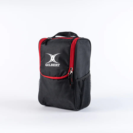 The black/red Gilbert Club V4 Boot Bag, featuring a front pocket, side mesh pocket, red zippers, and carrying handle, stands upright against a plain white background.