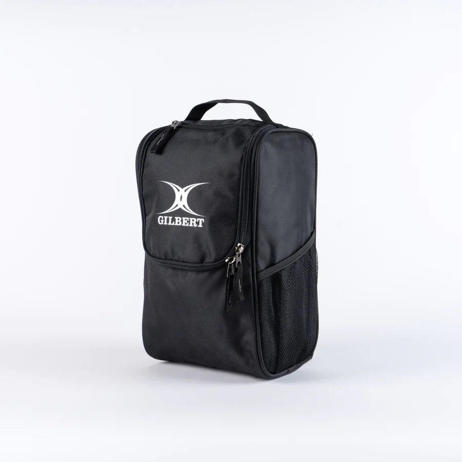 The Gilbert Club V4 Boot Bag by Gilbert is a black rectangular bag featuring a handle, zippered compartments, side mesh pocket, and the white GILBERT logo on the front, shown against a plain white background.