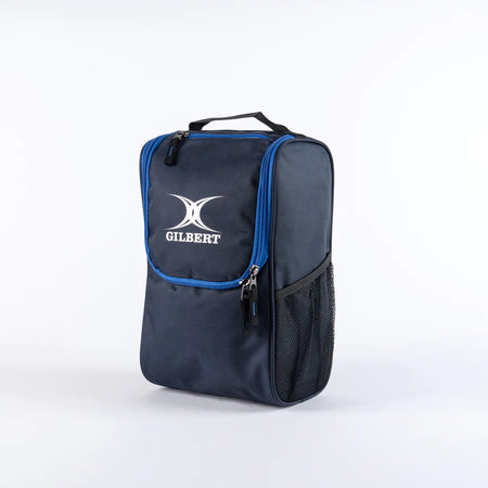 The Gilbert Club V4 Boot Bag by Gilbert in Navy/Royal features a zippered main compartment, blue trim, black mesh side pocket, and a top carrying handle, shown upright against a white background.