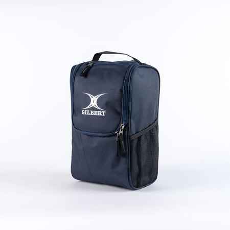 The Gilbert Club V4 Boot Bag by Gilbert, in navy, features a zippered top, front pocket, mesh side pocket, and black handle. The bag is shown against a plain white background.
