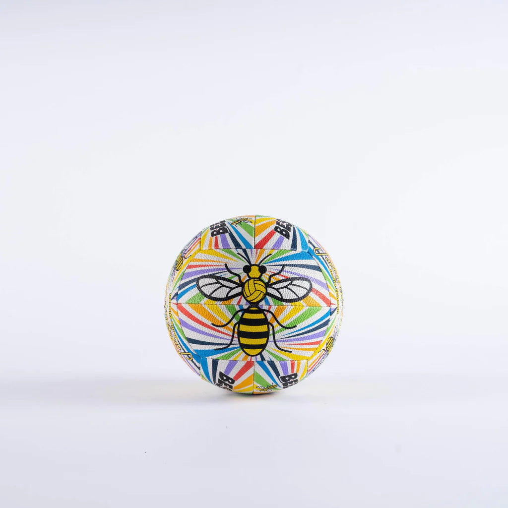 The Gilbert Ambassador Signature Netball by Gilbert features a geometric design and a bold black and yellow bee at the center. This size 5 ball stands out against a plain white background.