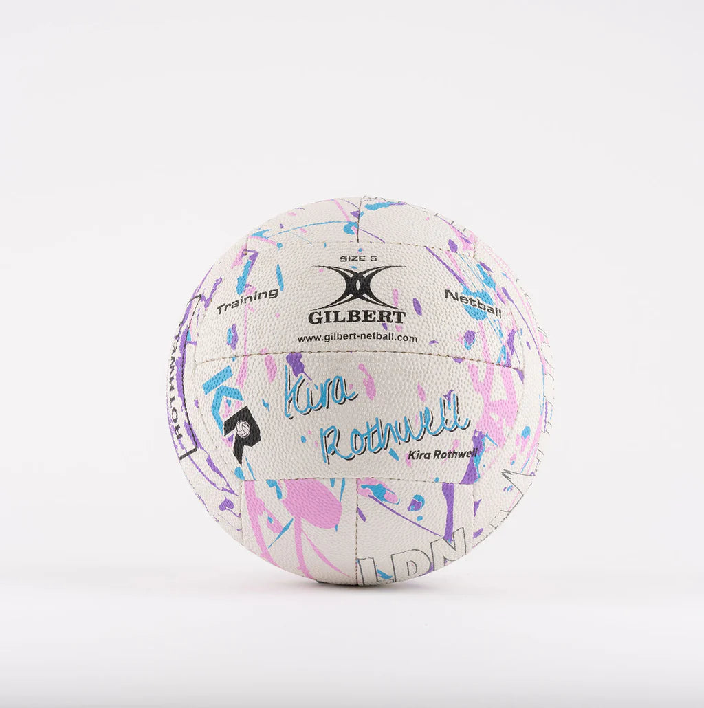 The Gilbert Ambassador Signature Netball by Gilbert is a size 5 white ball featuring vibrant blue, pink, and purple abstract patterns with “Kira Rothwell” printed on it—ideal as a signature ball against a plain white background.